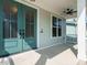 Inviting covered porch features a ceiling fan and striking double doors with glass panels, creating a grand entrance at 2013 Woodbluff Dr, Wendell, NC 27591