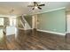 Spacious open-concept living area, kitchen island, and staircase featuring hardwood floors, and modern lighting at 2013 Woodbluff Dr, Wendell, NC 27591