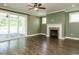 Spacious living room features a cozy fireplace, hardwood floors, and sliding glass doors to the outdoor living space at 2013 Woodbluff Dr, Wendell, NC 27591
