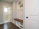 Mudroom featuring a built-in bench with hooks, wood accents, and hardwood floors at 2013 Woodbluff Dr, Wendell, NC 27591