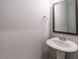 Stylish powder room showcases a pedestal sink with chrome fixtures and modern towel rack at 2013 Woodbluff Dr, Wendell, NC 27591