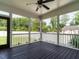 Outdoor screened in porch with dark wood floors and views of the backyard at 2013 Woodbluff Dr, Wendell, NC 27591