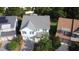 Aerial view of the home with a gray roof, blue siding, a two car garage, and mature landscaping at 205 Bog Hill Ln, Cary, NC 27519