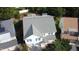 Aerial view of the home with a gray roof, blue siding, a two car garage, and mature landscaping at 205 Bog Hill Ln, Cary, NC 27519