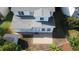 Birds-eye view of a home's backyard featuring a patio, well-kept lawn and various trees and foliage at 205 Bog Hill Ln, Cary, NC 27519