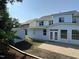 Back exterior of the home with a gray roof, blue siding, a patio, and a shed at 205 Bog Hill Ln, Cary, NC 27519