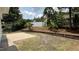 Backyard with brick paver patio, mature trees, and a white fence at 205 Bog Hill Ln, Cary, NC 27519