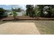 Backyard with a brick paver patio, mature trees, and white fence at 205 Bog Hill Ln, Cary, NC 27519