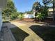 Backyard featuring lush greenery, including tropical plants and manicured mulch beds at 205 Bog Hill Ln, Cary, NC 27519