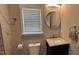 Bathroom with a vanity, round mirror, marble countertop, and decorative lighting at 205 Bog Hill Ln, Cary, NC 27519