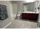 Bathroom featuring a shower and bath tub combination and a double sink vanity at 205 Bog Hill Ln, Cary, NC 27519