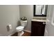 Powder room featuring granite countertop, decorative lighting, and stylish decor at 205 Bog Hill Ln, Cary, NC 27519