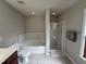 Bathroom featuring a soaking tub, tiled shower, and modern fixtures at 205 Bog Hill Ln, Cary, NC 27519
