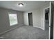 Bedroom with neutral walls, gray carpet, and sliding closet doors at 205 Bog Hill Ln, Cary, NC 27519