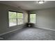 Bedroom with carpet, two windows allowing natural light, and neutral walls at 205 Bog Hill Ln, Cary, NC 27519