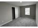 Bedroom with neutral walls, carpet, window, and closet with doors at 205 Bog Hill Ln, Cary, NC 27519
