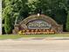The welcoming Twin Lakes community sign is surrounded by colorful foliage and manicured landscaping at 205 Bog Hill Ln, Cary, NC 27519