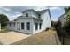 Light blue two-story home with a brick patio and fenced yard at 205 Bog Hill Ln, Cary, NC 27519