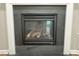 Fireplace set in a black tile surround, framed by white trim at 205 Bog Hill Ln, Cary, NC 27519