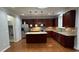 Modern kitchen features granite countertops, stainless steel appliances, and dark-wood cabinetry at 205 Bog Hill Ln, Cary, NC 27519