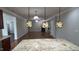 Bright, airy kitchen with granite counters and three pendant lights viewed from center island at 205 Bog Hill Ln, Cary, NC 27519