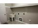 Functional laundry room with sink, tiled floor, and washer/dryer hookups at 205 Bog Hill Ln, Cary, NC 27519