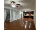 Open-concept living room featuring hardwood floors, staircase, and kitchen in the background at 205 Bog Hill Ln, Cary, NC 27519