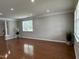 Open-concept living room with beautiful hardwood floors, neutral walls, and bright, natural light at 205 Bog Hill Ln, Cary, NC 27519