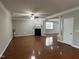 Spacious living room with hardwood floors, a fireplace, and an open floor plan at 205 Bog Hill Ln, Cary, NC 27519