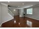 Expansive living room featuring hardwood floors, neutral walls, and staircase to the second floor at 205 Bog Hill Ln, Cary, NC 27519