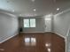 Spacious, light-filled living room with hardwood floors, white trim, and a view of the front yard at 205 Bog Hill Ln, Cary, NC 27519