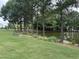 Scenic view of a community pond surrounded by lush greenery and trees at 205 Bog Hill Ln, Cary, NC 27519