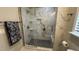 Modern bathroom with marble tile shower, glass enclosure, and brushed nickel hardware at 205 Bog Hill Ln, Cary, NC 27519
