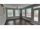 Bright sunroom featuring hardwood floors, ceiling fan and many windows offering ample natural light at 205 Bog Hill Ln, Cary, NC 27519