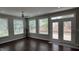 Bright sunroom with hardwood floors, white trim, multiple windows, and access to the backyard at 205 Bog Hill Ln, Cary, NC 27519