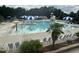 Large community pool with slide, umbrellas, and poolside lounge chairs at 205 Bog Hill Ln, Cary, NC 27519