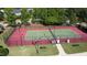 Overhead view of fenced tennis court; benches and light posts around perimeter at 205 Bog Hill Ln, Cary, NC 27519