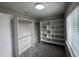 Spacious walk-in closet with custom wood and white shelving and gray carpeting at 205 Bog Hill Ln, Cary, NC 27519