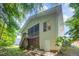 Exterior of house with wood paneling, screened porch, stairs, deck, and a partial view of the backyard at 209 Homegate Cir, Apex, NC 27502