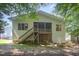 Back of home with a screened porch, deck, wooden stairs, and a well-maintained yard at 209 Homegate Cir, Apex, NC 27502