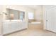 Bright bathroom featuring dual sinks, a soaking tub, and tile floors at 209 Homegate Cir, Apex, NC 27502