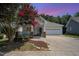 Charming home featuring a well-manicured lawn, a porch, and a two-car garage at 209 Homegate Cir, Apex, NC 27502