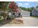Inviting single-story home with a well-manicured lawn and a charming covered front porch at 209 Homegate Cir, Apex, NC 27502