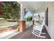Relaxing covered front porch with rocking chairs and a ceiling fan at 209 Homegate Cir, Apex, NC 27502