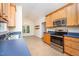 Eat-in kitchen features stainless steel appliances, wood cabinets, and lots of natural light at 209 Homegate Cir, Apex, NC 27502