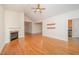 Bright living room with a fireplace, ceiling fan and beautiful hardwood floors at 209 Homegate Cir, Apex, NC 27502