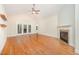 Bright living room with hardwood floors, fireplace, and access to the backyard at 209 Homegate Cir, Apex, NC 27502