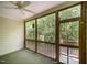 Relaxing screened porch with ceiling fan, wood trim, and view of lush greenery at 209 Homegate Cir, Apex, NC 27502