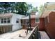 Inviting back deck with swing overlooking the backyard and mature trees at 2100 Breeze Rd, Raleigh, NC 27608