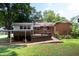 The backyard features a spacious back deck area and a mature tree line at 2100 Breeze Rd, Raleigh, NC 27608